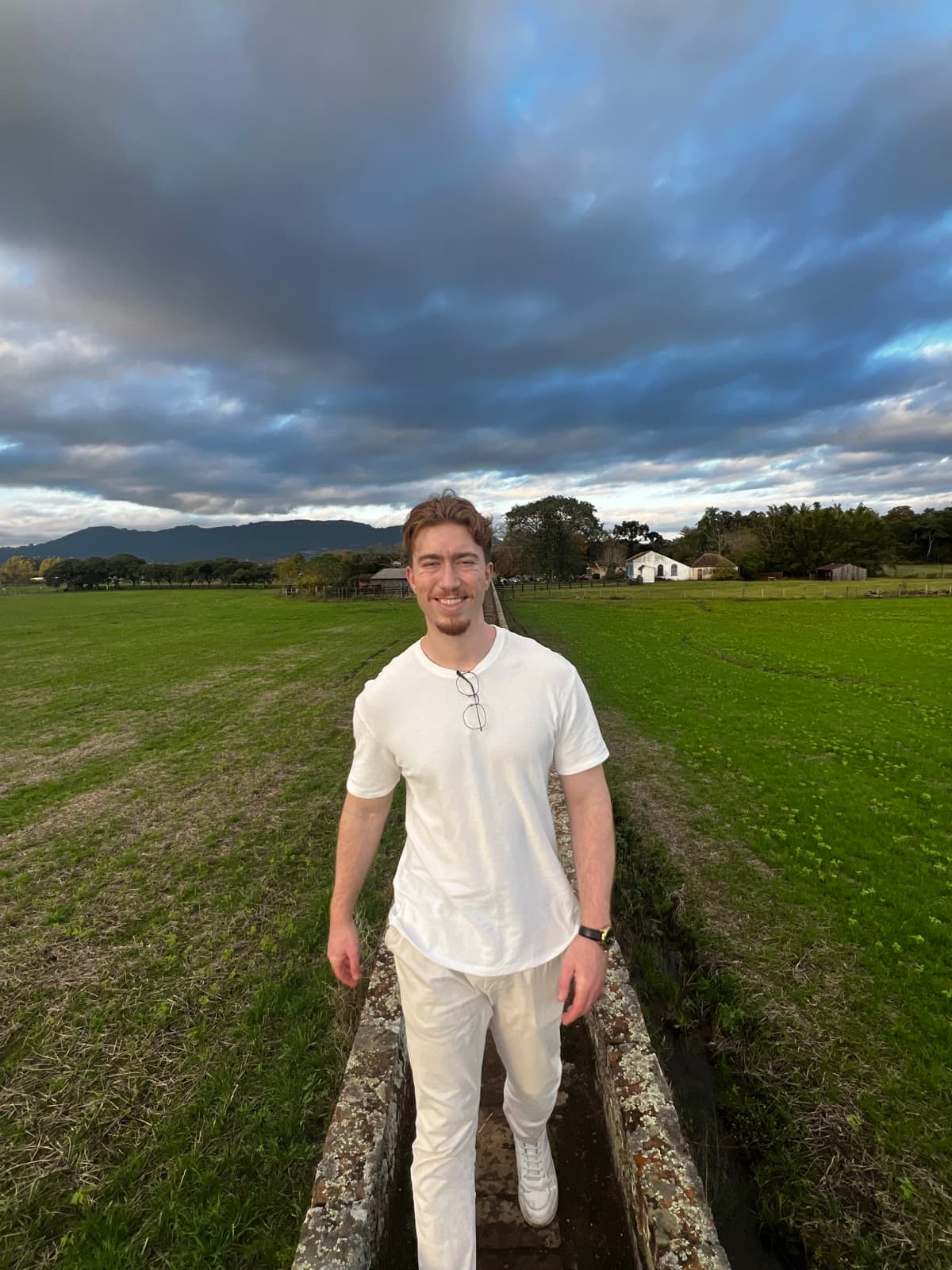 Mateus Berlitz walking through a field in the countryside of southern Brazil